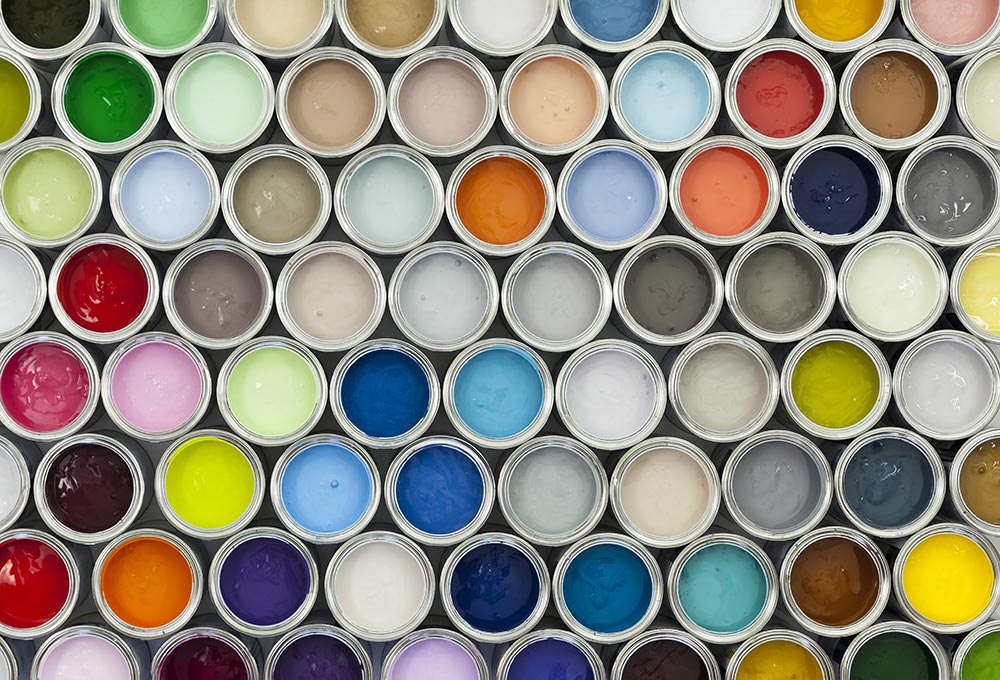 Aerial view of open paint cans, showing paint inside of them.