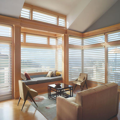 Hunter Douglas Window Treatments Silhouette in a living room with natural wood window trim.