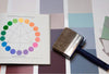 A color wheel beside a paint brush.