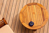 Aerial view of an exterior wooden deck with a wooden table and beige chair.